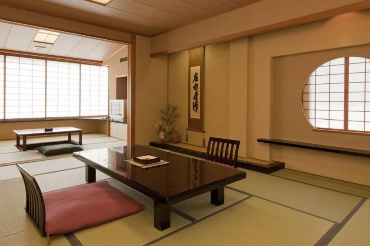A traditional Japanese room with tatami flooring, a low table, and a shoji screen.