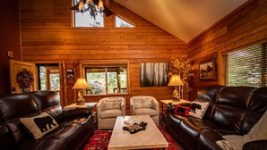 A log cabin interior with leather sofas, a coffee table, and two lamps. - Hot Tub, Arcade Room, Fire Pit, 3 Min to Uptown Pagosa, Private Colorado Setting (Pagosa Springs)