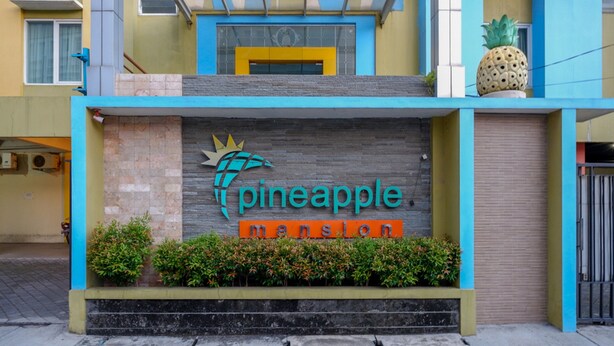 Un edifici amb un rètol que diu "pineapple mansion".