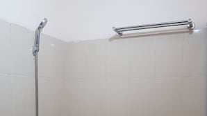 A shower area with a handheld showerhead and a grab bar. - Waringin Residence (Medan)
