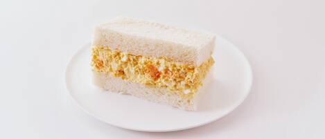A slice of cake on a white plate.