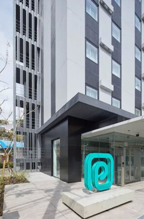 A modern building with a glass entrance and a prominent Instagram logo. - Prince Smart Inn Atami (Atami)