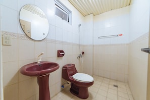 A bathroom with a sink, toilet, and shower. - RedDoorz Plus @ Subic 2n2 Beach Resort Zambales (Subic)