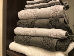 Bathtub, towels, soap, toilet paper