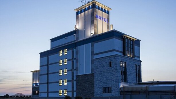 A modern hotel with a prominent tower labeled "HOTEL" and multiple windows. - NOA HOTEL Toyotaminami - Adults Only (Anjo)
