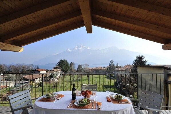 A table set for dining with a mountain view in the background.