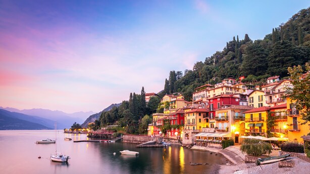 A coastal town with colorful buildings, a calm lake, and boats. - Alto Perledo Terrazzo (Perledo)