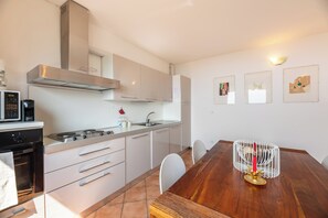 Family Apartment, Multiple Bedrooms, Mountainside (Alto Perledo Terrazzo) | Private kitchen | Fridge, microwave, oven, stovetop