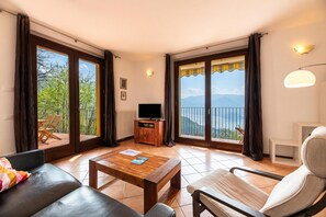 Family Apartment, Multiple Bedrooms, Mountainside (Alto Perledo Terrazzo) | Living area | Flat-screen TV