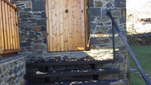 A stone building with wooden steps and a door. - Duplex 3 Bed Rustic Style, Fireplace, Terrace & Cadí Views (Guils de Cerdanya)