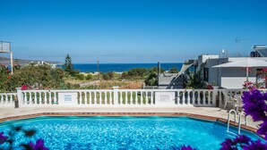 A swimming pool with a view of the sea, surrounded by a white fence and a sign indicating no diving. - Rouladina Apt 2 (Stalos)