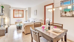 Een moderne hotelkamer met een zithoek, een bed met uitzicht en een groot raam.