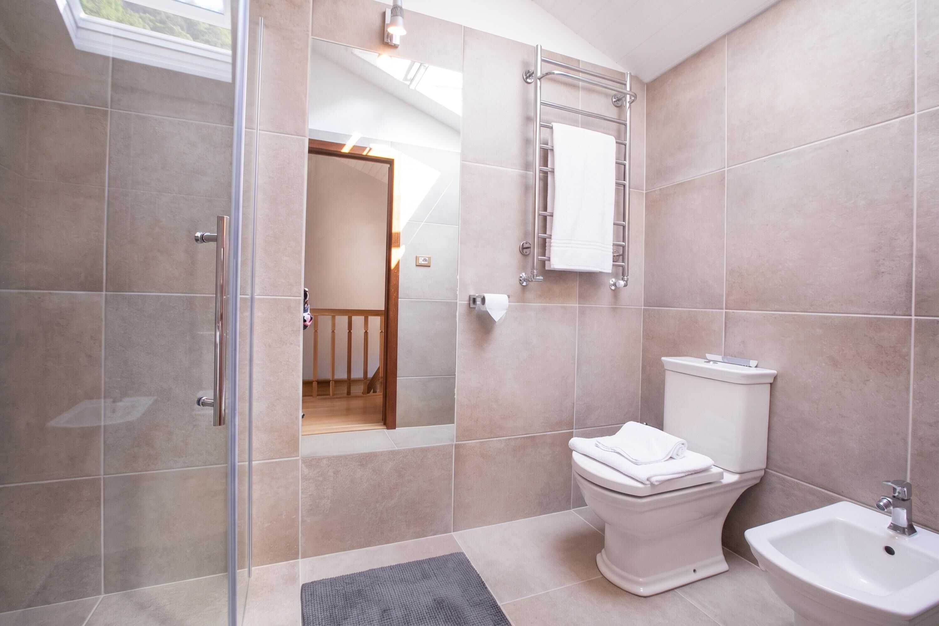 A modern bathroom with a toilet, bidet, and sink.