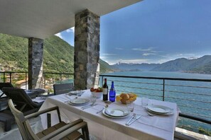 Enjoy a romantic meal for two on this balcony overlooking the serene water and majestic mountains.