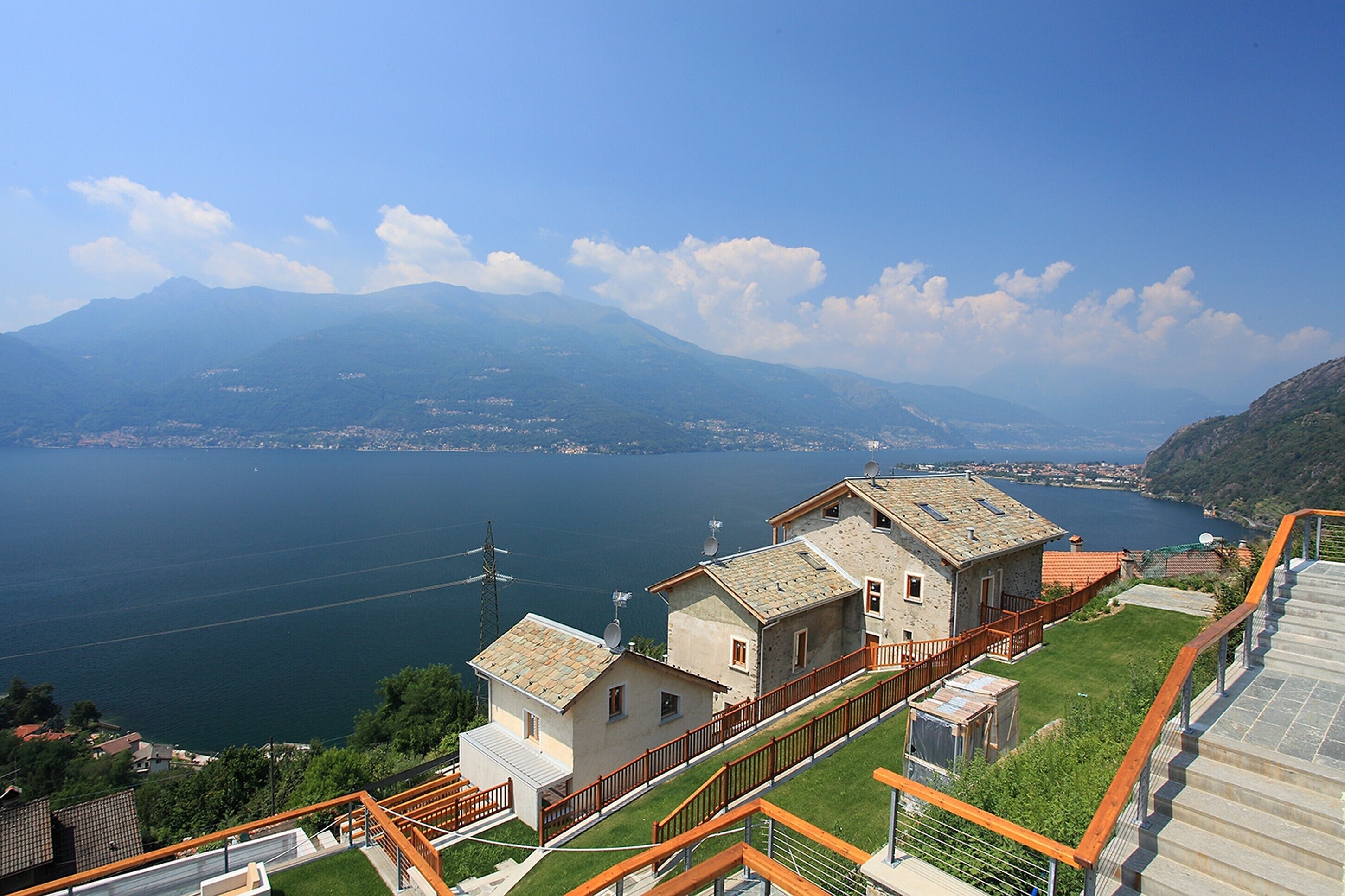 A coastal property with a view of the sea and mountains.