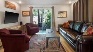 A living room with a sofa, chairs, a coffee table, and a TV. - 2-BR Condo by Vail Resort: Outdoor Patio, Parking (Vail)