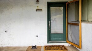 A room with a green door, a small mailbox, and a doormat. - 2-BR Condo by Vail Resort: Outdoor Patio, Parking (Vail)