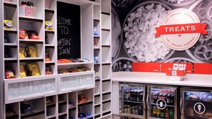 A self-service snack and drink station with various snacks and beverages, including popcorn and sodas. - Hampton Inn Lexington, NC (Lexington)