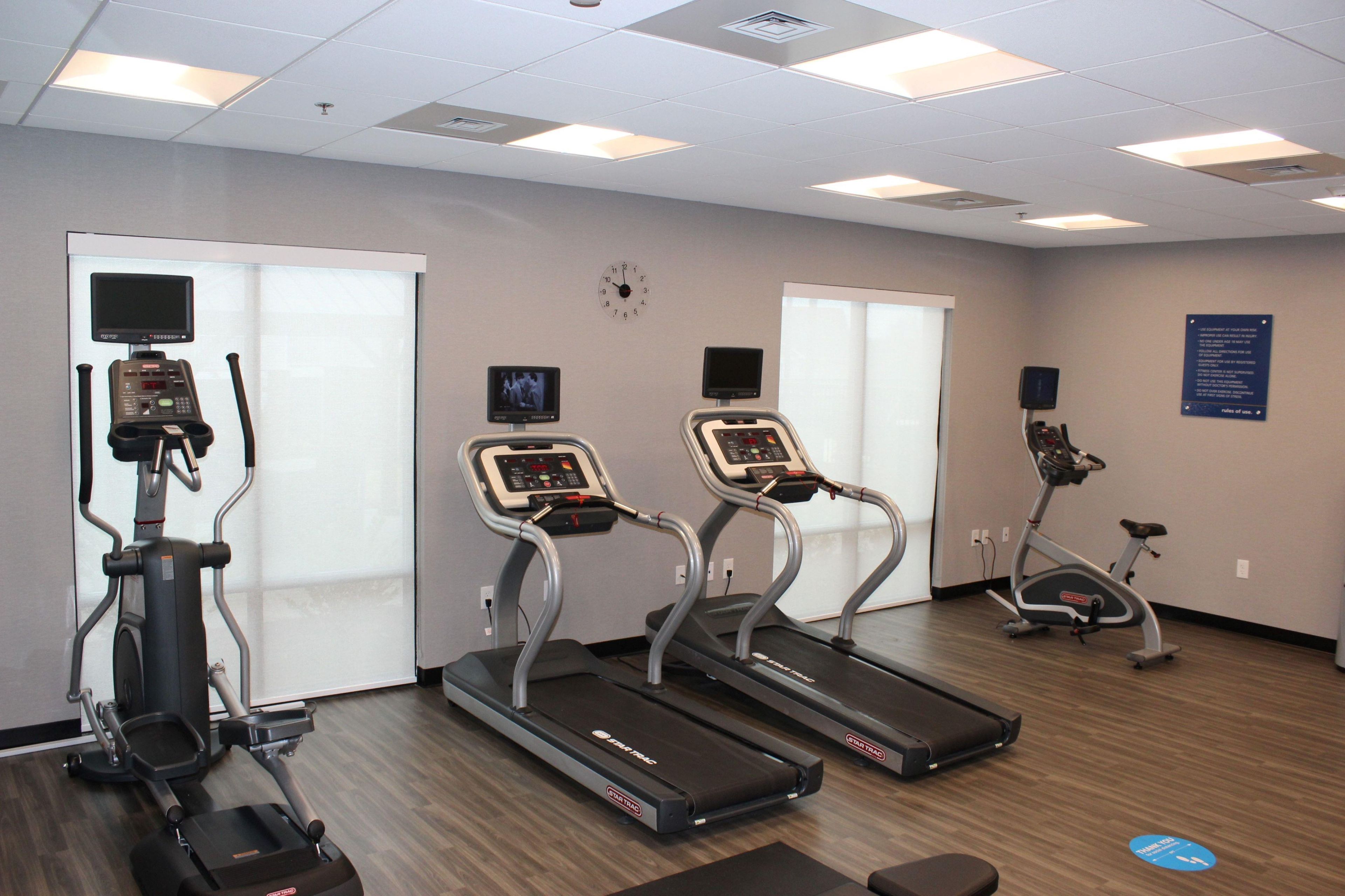 A fitness center with treadmills, an elliptical, and a stationary bike.
