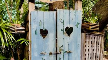 A rustic wooden gate with a sign that reads 'BLUE HEAVEN Showers & Watch $2.00'.