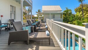 A covered outdoor area with wicker furniture and a pool. - FONTANA ~ Adults Only, Poolside King Room at Azul Mansion! (Key West)