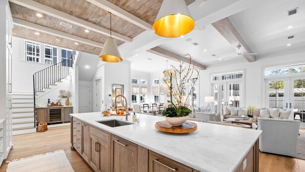 A spacious kitchen with a large island, wooden cabinets, and pendant lighting. - Spacious Porch with Pool and Firepit (Panama City Beach)