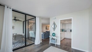 A modern interior with a dining area, a kitchen, and a living space.