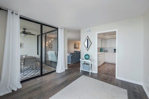 A modern interior with a dining area, a kitchen, and a living space. - Bayshores - William Raveis Rentals (Naples)