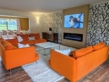 Huge 24x24 living room with smart TV, electric fireplace and plenty of seating.