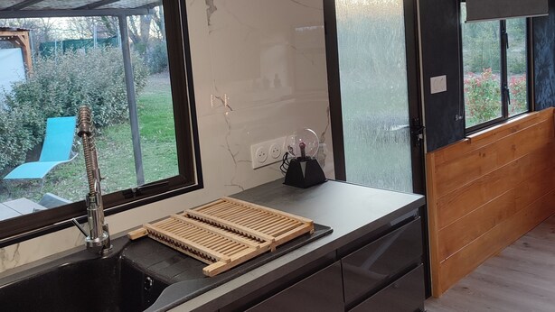 A modern kitchen with a large window, a built-in sink, and a wooden countertop. - Quiet and very few neighbors around (Riez)