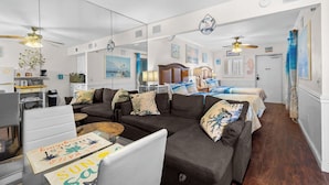 A cozy living area with a sectional sofa, a dining table, and a ceiling fan. - Waterside, Studio #21, Family Friendly, Close to Beach (Clearwater Beach)