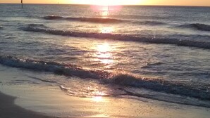 A beach at sunset with waves, a sandy shore, and a distant horizon. - Waterside, Studio #21, Family Friendly, Close to Beach (Clearwater Beach)
