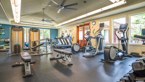 A gym with various exercise equipment, including treadmills, elliptical machines, and free weights. - Luxurious Ho'olei 12-2, Lush View, Close to Pool, Sleeps 8 in beds, Central AC! (Kihei)