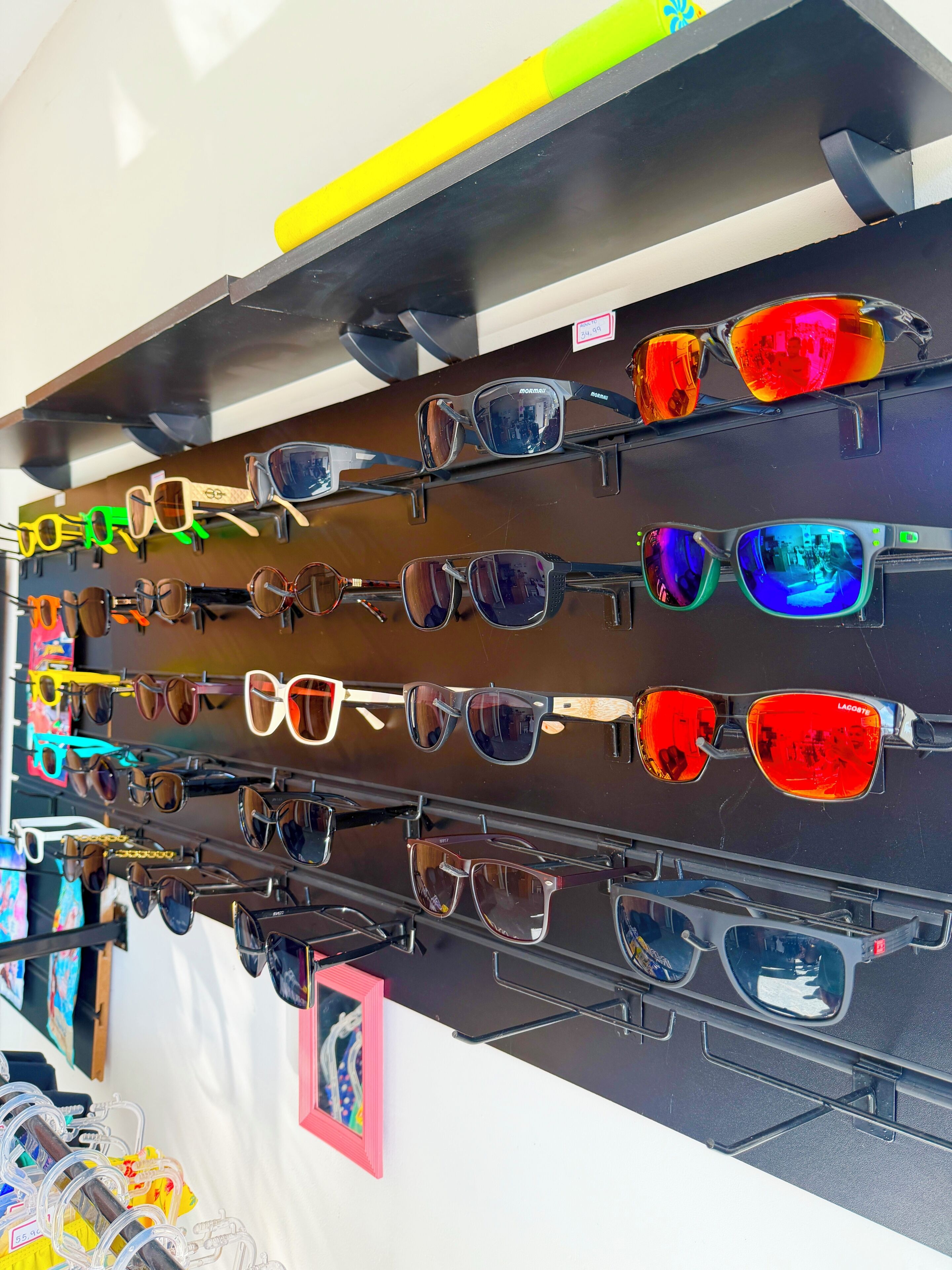 A variety of sunglasses displayed on a rack.