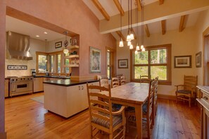 Enjoy meals in the kitchen with an oven and dining area with a wooden table.