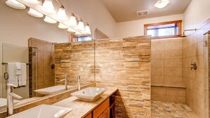 A modern bathroom with two sinks, a shower, and a large mirror. - Black Canyon Inn Unit H1 Deluxe (Estes Park)