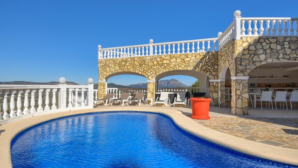 A swimming pool with a stone deck, white railings, and a view of mountains. - Large and nice villa  with private pool in Benitachell, on the Costa Blanca, Spain for 8 persons (Benitachell)