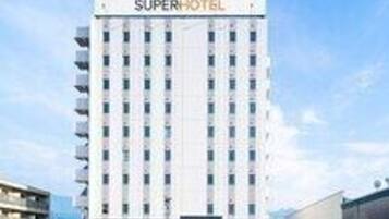 A Super Hotel with a modern design, featuring a central entrance and multiple floors.