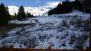 A snowy mountain landscape with a wooden fence in the foreground. - High-end 4-room duplex at the foot of the slopes with parking (Les Adrets-Prapoutel)