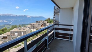 A balcony with a view of a mountainous landscape.