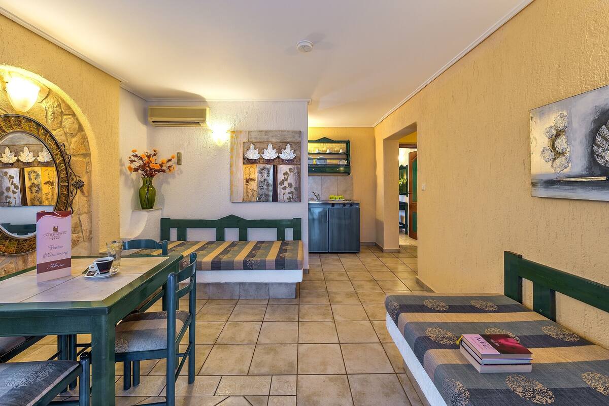 A dining area with a table, chairs, a bench, and a wall-mounted mirror.