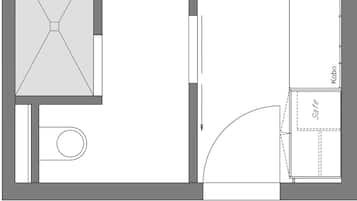 Grundriss eines Hotelzimmers mit Bett, Bad, Küchenzeile und Wohnbereich.