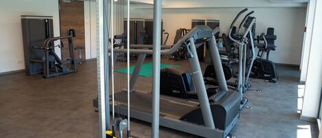 A gym with treadmills, ellipticals, and weight machines.
