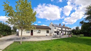 A two-story house with a front yard and a driveway. - Converted Stables - Pet Friendly - Enclosed Garden (Pontefract)
