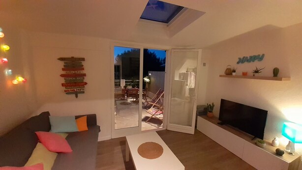 A living room with a sofa, TV, and a glass door leading to an outdoor area. - Mazet between Gassin and Cogolin, 5 km from Saint Tropez (Gassin)