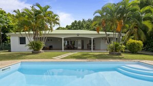 A house with a swimming pool, surrounded by palm trees and a well-maintained lawn. - Nature Paradise - Four Bedroom Villa, Sleeps 8 (Rivière-Pilote)