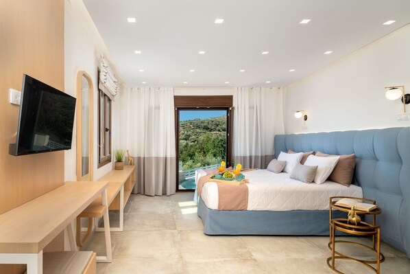 A modern bedroom with a bed, a desk, and a TV.