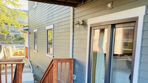 A wooden deck with a glass door leading to a bedroom. - Premier Downstairs Flat in Perfect Down Town Location  (Ashland)