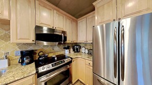 Fully equipped kitchen with stove, oven, microwave, and refrigerator.