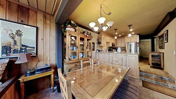 Enjoy meals in the well-appointed kitchen with a central island, dining table, and modern appliances.